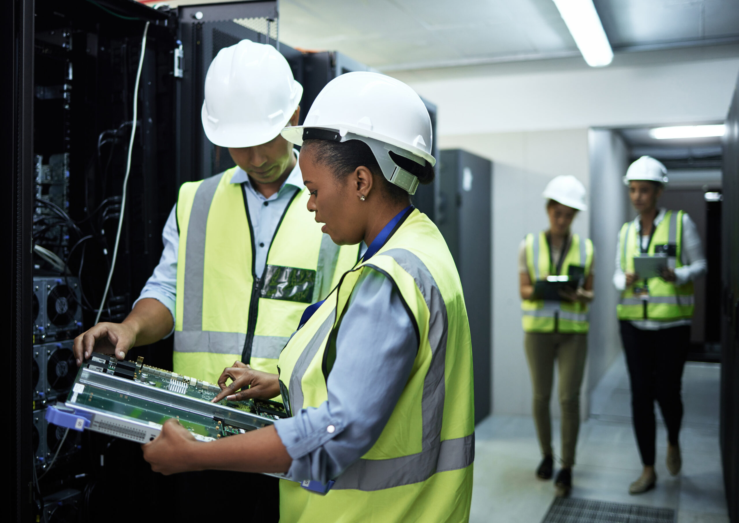 Technology doctors. Cropped shot of a group of computer programmers working in a server room